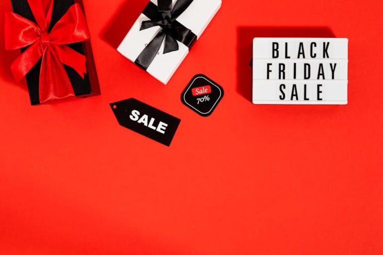 Flat lay of Black Friday sale promotion with gift boxes on a red background. Ideal for shopping and marketing visuals.