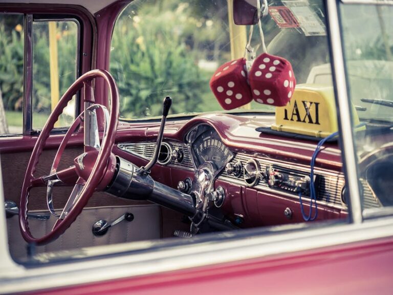 Classic car interior with retro taxi sign and red dice ornament.