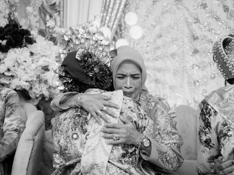 A heartfelt embrace between family members during a traditional Indonesian wedding.