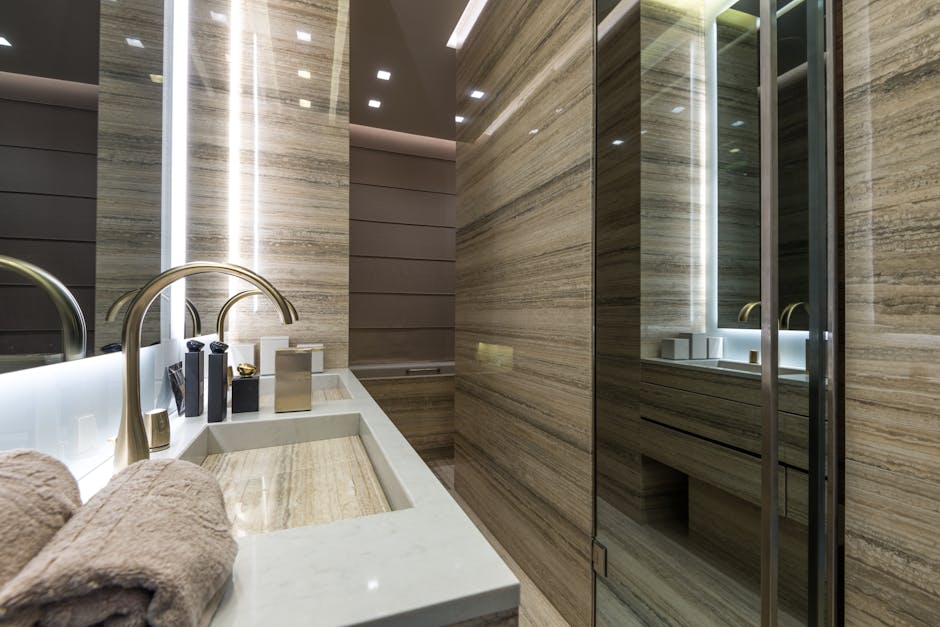 A contemporary bathroom featuring sleek marble surfaces, elegant fixtures, and ambient lighting.