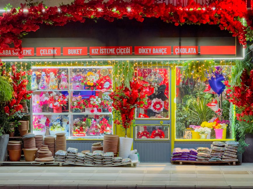 A vibrant floral shopfront in Elâzığ, Türkiye, illuminated at night with colorful flowers and decorative lighting.