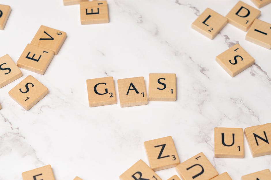 Scrabble tiles on marble spelling 'Gas', perfect for energy concept visuals.