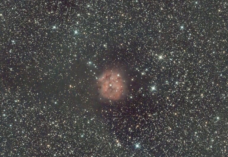 A breathtaking view of the Rosette Nebula surrounded by countless stars in the night sky.