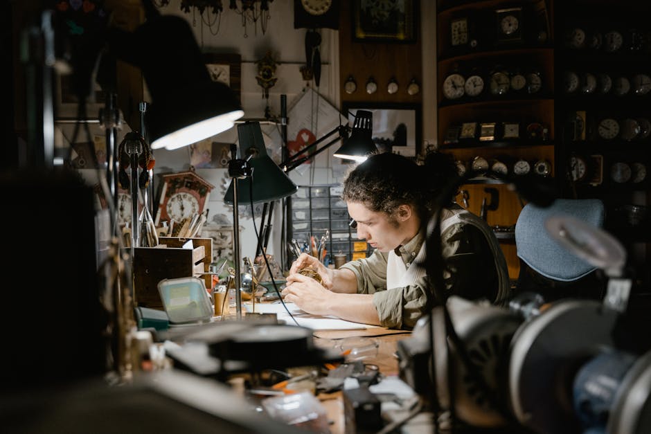A dedicated watchmaker repairs a watch at a cluttered workbench in a dimly lit workshop.