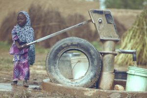 Child fetching water from a well in Katsina, Nigeria, symbolizing rural life.
