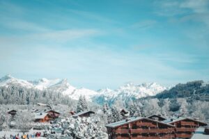 Snow-covered chalets in Megève with majestic mountain backdrop.