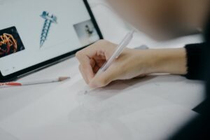 An artist sketching in a contemporary studio in Tokyo, featuring a digital tablet and pencil.