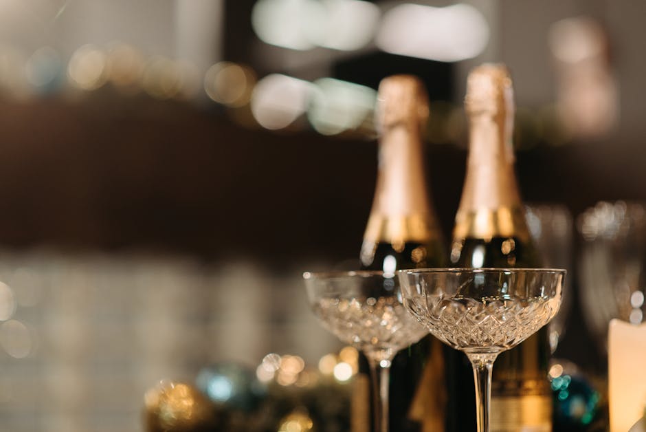 Two champagne bottles and crystal flutes on a festive table, perfect for celebrations.