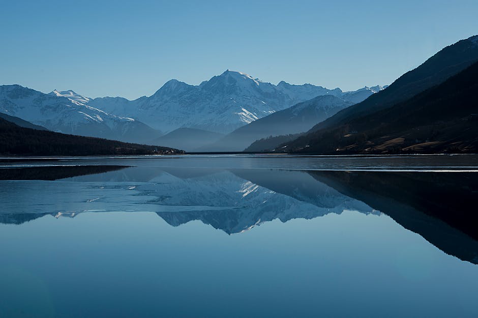 Peaceful mountain landscape with clear reflections in a calm lake.